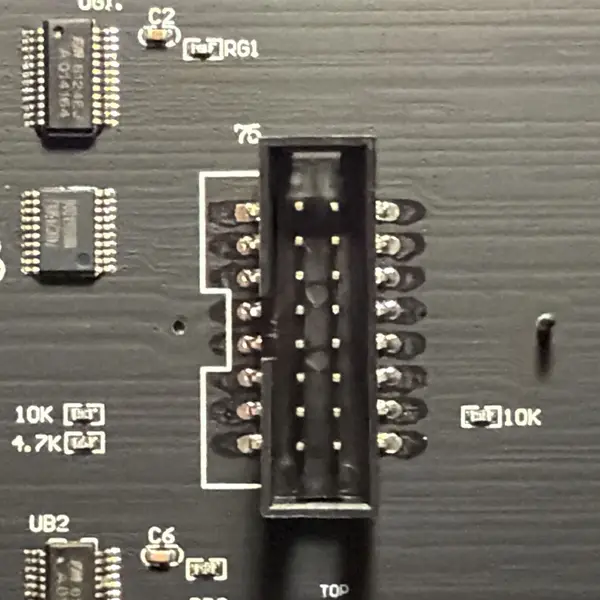 The back of an LED panel: the HUB75 input connector with two small buffer chips beside it