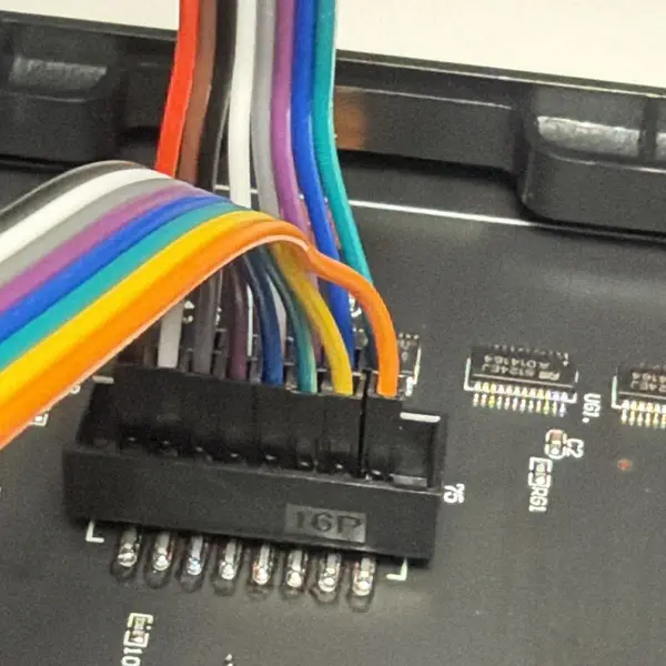 Rainbow jumper wires pushed into the panel's input connector